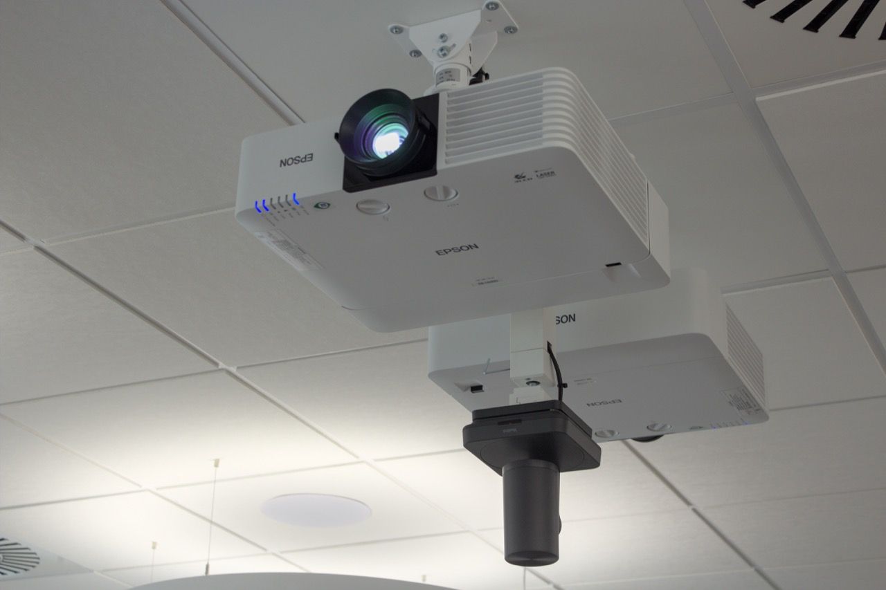 Epson-Laserprojektor mit leuchtendem Objektiv, darunter die PTZ-Kamera